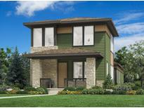 Two-story home featuring a covered porch with stone accents, green siding and beautifully landscaped front yard at 2341 Superior Dr, Superior, CO 80027