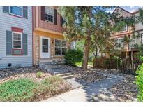Charming townhome exterior with stone accents, front yard landscaping, and a welcoming entrance at 12059 E Hoye Dr, Aurora, CO 80012