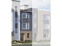 Modern townhome showcasing vertical and horizontal siding and brick facade, creating an eye-catching street view at 14279 Currant St, Broomfield, CO 80020