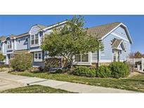 Charming blue townhome with stone accents and well-maintained landscaping; perfect for comfortable living at 5873 Ceylon St # E, Denver, CO 80249
