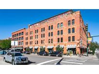 Charming brick building exterior with retail space and a rooftop garden, perfect for urban living at 1745 Wazee St # 4G, Denver, CO 80202