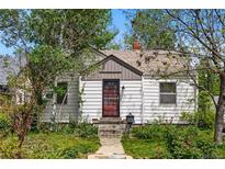 Charming home with white siding, a well-maintained yard, and a welcoming front entrance at 5674 S Prescott St, Littleton, CO 80120