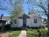 Charming single story home with a well maintained lawn, walkway and mature shade trees at 5674 S Prescott St, Littleton, CO 80120