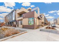 Modern townhome with brick exterior and landscaped walkway at 1694 Quitman St, Denver, CO 80204