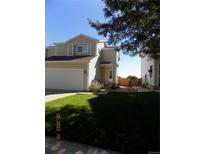 Charming townhome with a well-manicured lawn, attached garage, and inviting front porch at 7982 S Kittredge Way, Englewood, CO 80112
