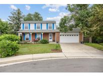 Charming two-story home featuring a well-manicured front lawn, brick accents, and an attached two-car garage at 3308 W 11Th Avenue Pl, Broomfield, CO 80020
