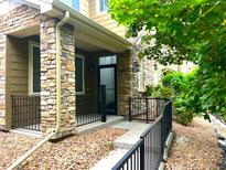 Charming home with a stone front porch and black metal railings at 11282 Osage N Cir # F, Northglenn, CO 80234