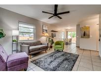 Bright living room features stylish furnishings, a ceiling fan, and neutral tile flooring at 999 Osceola St, Denver, CO 80204