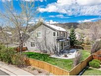 A charming backyard with a green lawn and a patio set, perfect for outdoor dining and entertaining at 9407 W Gibraltar Pl, Littleton, CO 80127