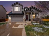 Charming two-story home with covered porch and well-maintained landscaping at 9407 W Gibraltar Pl, Littleton, CO 80127