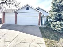 Charming single-Gathering home with a spacious three-car garage and a well-maintained front yard at 5343 S Ukraine Way, Aurora, CO 80015