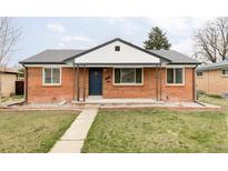 Charming brick home featuring a well-manicured lawn and classic architectural details at 2340 Jamaica St, Aurora, CO 80010