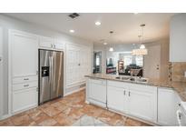 Bright kitchen boasts stainless steel appliances, granite countertops, and abundant white cabinetry at 12281 E Tennessee Dr # 303, Aurora, CO 80012