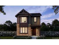 Charming two-story home with stone accents and a beautifully landscaped front yard at 7249 Goldbloom Ln, Littleton, CO 80125