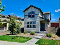 Charming two-story home featuring a landscaped front yard and a welcoming entrance, enhancing its curb appeal at 4770 N Jasper St, Denver, CO 80239