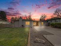 Charming single-story home with a well-maintained lawn and lovely landscaping at 7160 W 24Th Ave, Lakewood, CO 80214