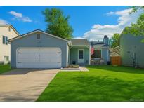 Charming single-story home with a well-manicured lawn and attached garage at 17616 Ponderosa Ave, Parker, CO 80134