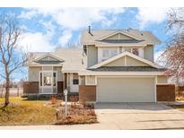 Charming two-story home with an attached garage and well-maintained front yard featuring an appealing roofline at 4547 Tally Ho Trl, Boulder, CO 80301