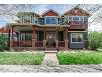 Charming two-story home featuring a spacious front porch, beautiful landscaping, and a welcoming entrance at 900 Wilshire Dr, Berthoud, CO 80513