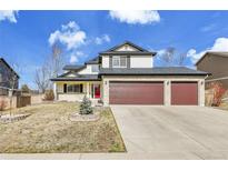 Charming two-story home with a three-car garage and well-maintained front yard at 5885 Kingsfield St, Castle Rock, CO 80104