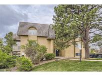 Inviting exterior showcasing a well-maintained building with a lush lawn and mature trees at 7455 E Quincy Ave # 103, Denver, CO 80237