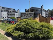 Lake Chalet community sign, with beautiful shrubbery and buildings in the background on a sunny day at 8100 W Quincy Ave # 11, Denver, CO 80123
