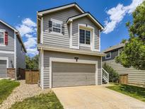 Charming two-story home features a two car garage and manicured lawn at 4287 Brookwood Pl, Highlands Ranch, CO 80130