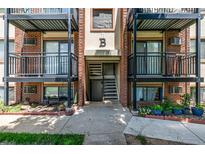A brick apartment building with black metal balconies and access stairs for each unit at 5995 W Hampden Ave # 20B, Denver, CO 80227
