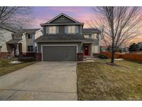 Charming two-story home with a well-maintained lawn and an attached two-car garage at 486 Balsa Dr, Castle Rock, CO 80104