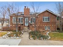 Charming brick home featuring landscaped front yard and inviting entrance with stone walkway at 4000 Irving St, Denver, CO 80211