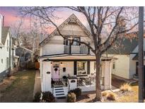 Charming two-story home with a covered front porch and decorative details under the gables at 858 S Emerson St, Denver, CO 80209