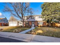 Charming two-story home with a well-manicured front yard and inviting walkway at 4074 S Poplar Way, Denver, CO 80237