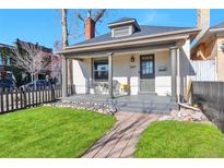 Charming home featuring a covered front porch with decorative chairs and a well-manicured lawn at 3601 N High St, Denver, CO 80205
