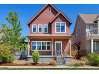 Inviting two-story home featuring a charming front porch and well-maintained landscaping at 1691 W 66Th Ave, Denver, CO 80221
