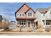 Charming two-story home with covered front porch and inviting curb appeal at 1691 W 66Th Ave, Denver, CO 80221