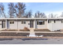 Charming townhouse featuring a well-maintained yard and gray brick exterior at 2401 W 39Th, Denver, CO 80211