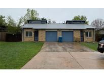 Charming brick home featuring attached garages and well-maintained front yard at 865 S Depew St, Lakewood, CO 80226