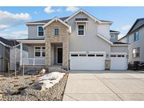 Charming two-story home with stone accents, a welcoming porch, and three-car garage at 3350 Backdrop Ct, Castle Rock, CO 80108