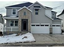 Two-story house with gray siding, stone accents, and a two-car garage at 3350 Backdrop Ct, Castle Rock, CO 80108