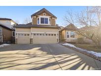 Charming two-story home featuring a three-car garage and well-maintained front yard at 17118 Knollside Ave, Parker, CO 80134