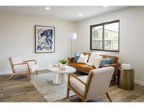 Bright living room featuring stylish decor, hardwood floors, and a modern sofa set at 10792 Moore St, Broomfield, CO 80021