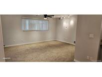 This bedroom features neutral walls, carpet flooring, ceiling fan and horizontal blinds at 12170 Huron St # 106, Denver, CO 80234