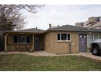 Charming single-story home with brick exterior, covered porch, and well-maintained front yard at 1375 N Iola St, Aurora, CO 80010