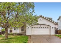 Charming home featuring an attached two-car garage and a well-maintained front lawn at 12507 Dexter Way, Thornton, CO 80241