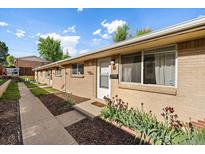 Charming home exterior featuring a brick facade, well-maintained yard, and inviting front entry at 10321 W 59Th Ave # 2, Arvada, CO 80004