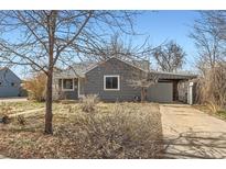 Charming single-story home with gray siding, a covered carport, and a well-maintained front yard at 755 Newark St, Aurora, CO 80010