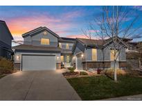 Charming two-story home features a landscaped yard, complemented by an attached two-car garage and beautiful sunrise at 11023 Pastel Pt, Parker, CO 80134