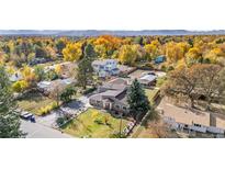 Stunning aerial view of home with beautiful, lush landscaping and mature trees in the surrounding neighborhood at 1945 Yarrow St, Lakewood, CO 80214