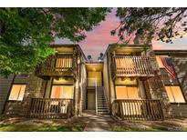 Charming condo building featuring balconies with stone accents and mountain views at sunset at 1758 S Pitkin Cir # A, Aurora, CO 80017