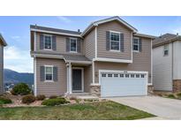 Two-story home with taupe siding, gray shutters, and a two-car garage in a well-maintained neighborhood at 1416 Red Mica Way, Monument, CO 80132